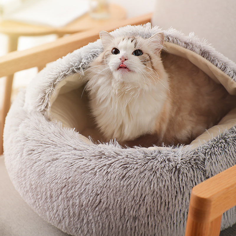 Cat sitting in a fluffy pet bed on a wooden chair