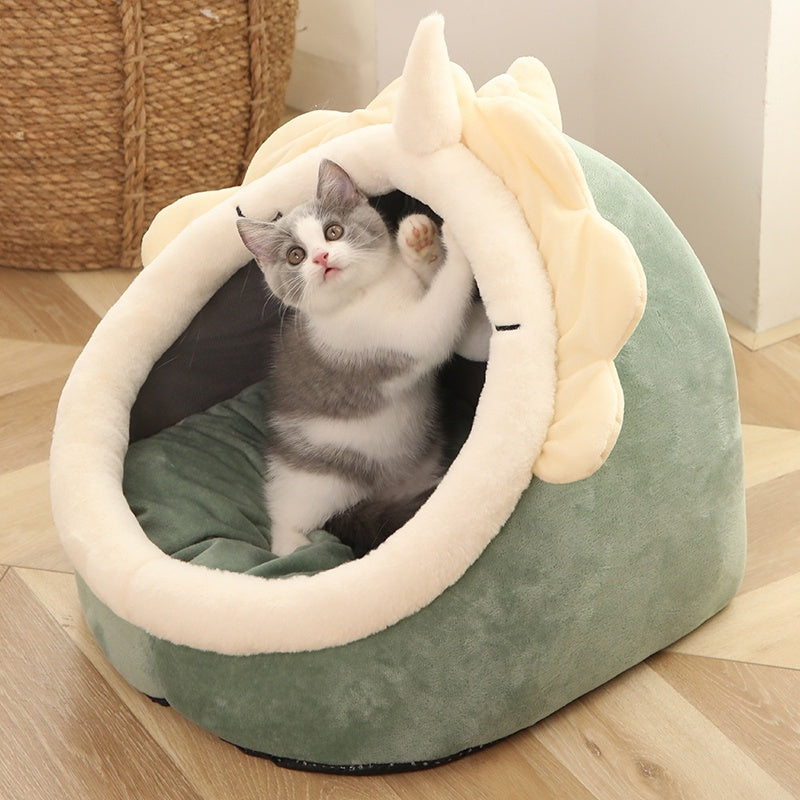 
Cat lying in a fluffy pink pet bed with a hand petting it