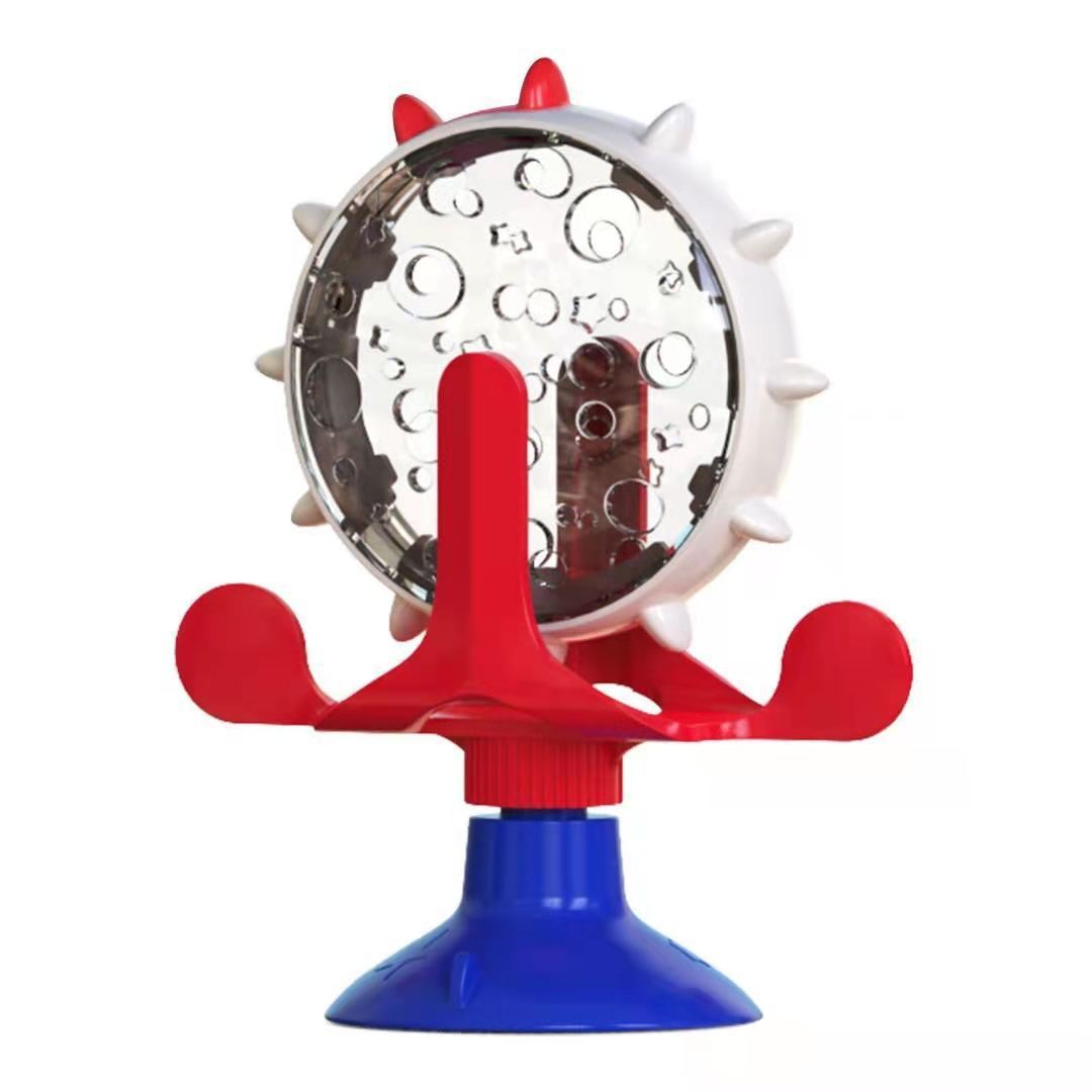 Red and blue bird toy with a circular metal component on a white background
