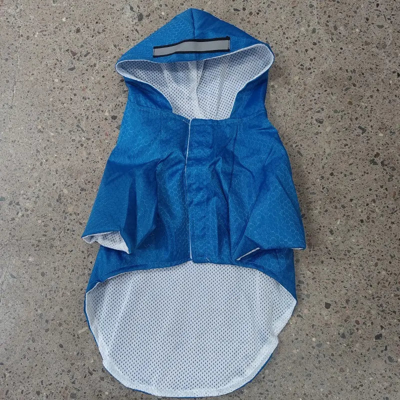 Blue raincoat with white lining on a concrete surface
